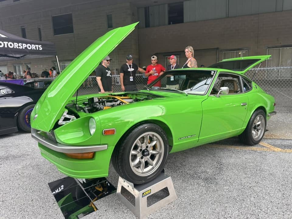 Lime, a bright green Datsun 240Z built by SoFlo Z Club, hood raised showing the detailed engine bay